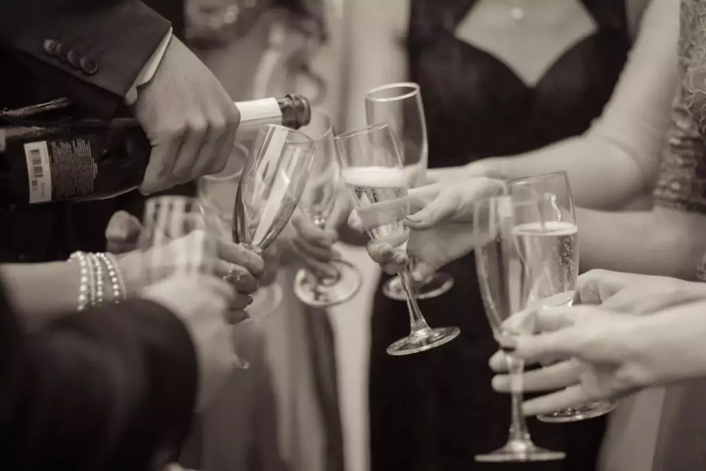 Guests clinking champagne glasses during a Stolen Dance Entertainment's signature reception package